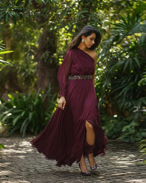 Burgundy one shoulder slit gown with belt.