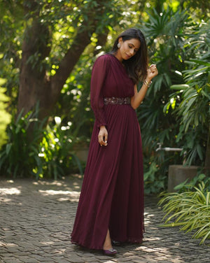 Burgundy one shoulder slit gown with belt.