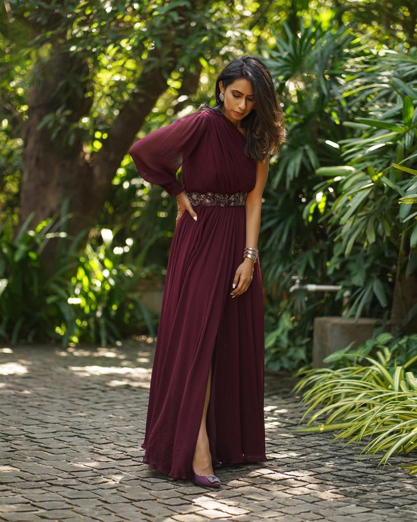 Burgundy one shoulder slit gown with belt.